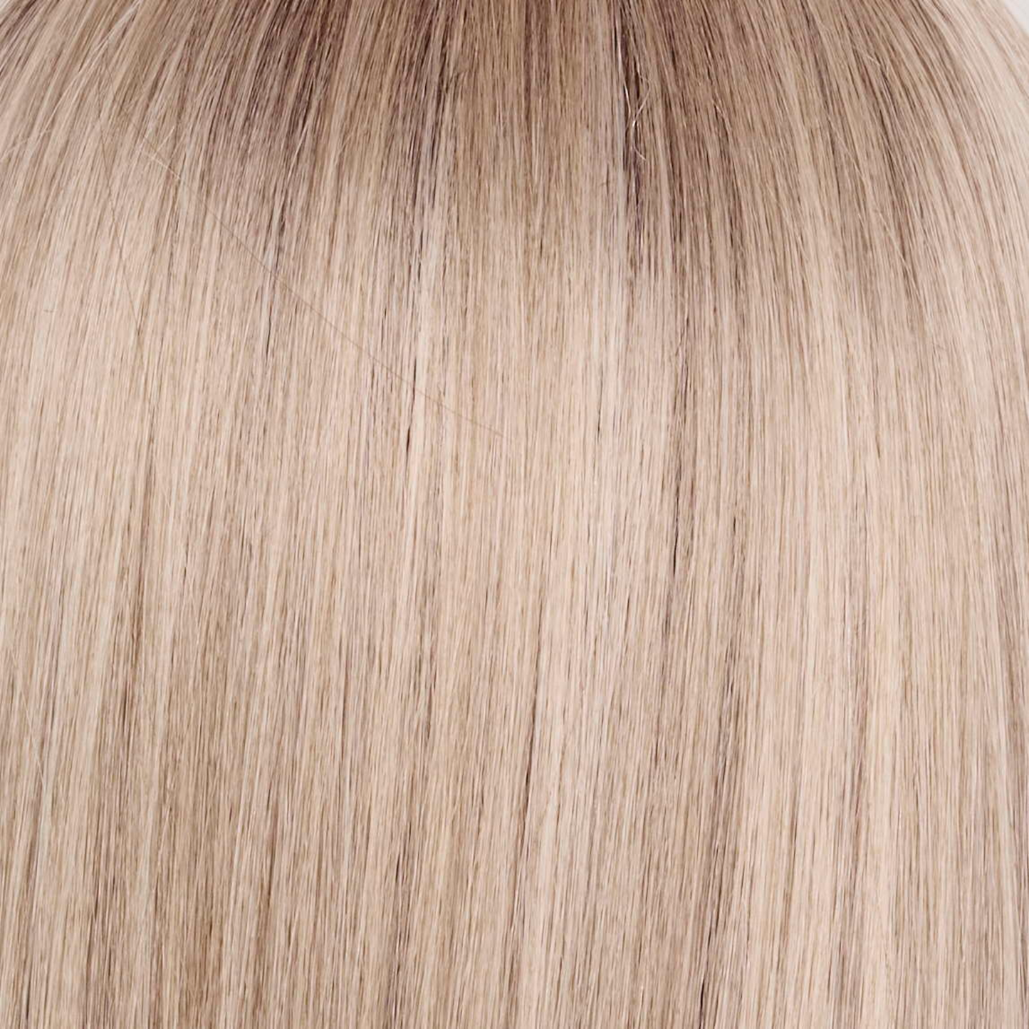 Billionaire Blond - A sophisticated hue featuring a rich mocha chocolate root that transitions into finely woven beige, ash, and cream blond tones. The face-framing luxurious cream and white blond highlights elevate the color