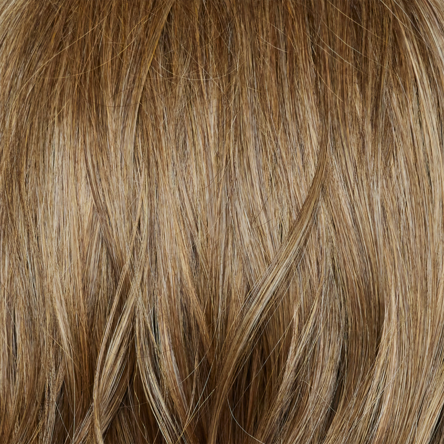 Caramel Biscotti - A beautiful mid/dark blond hair color with delicate caramel blond highlights seamlessly blended throughout, creating a warm and inviting look.