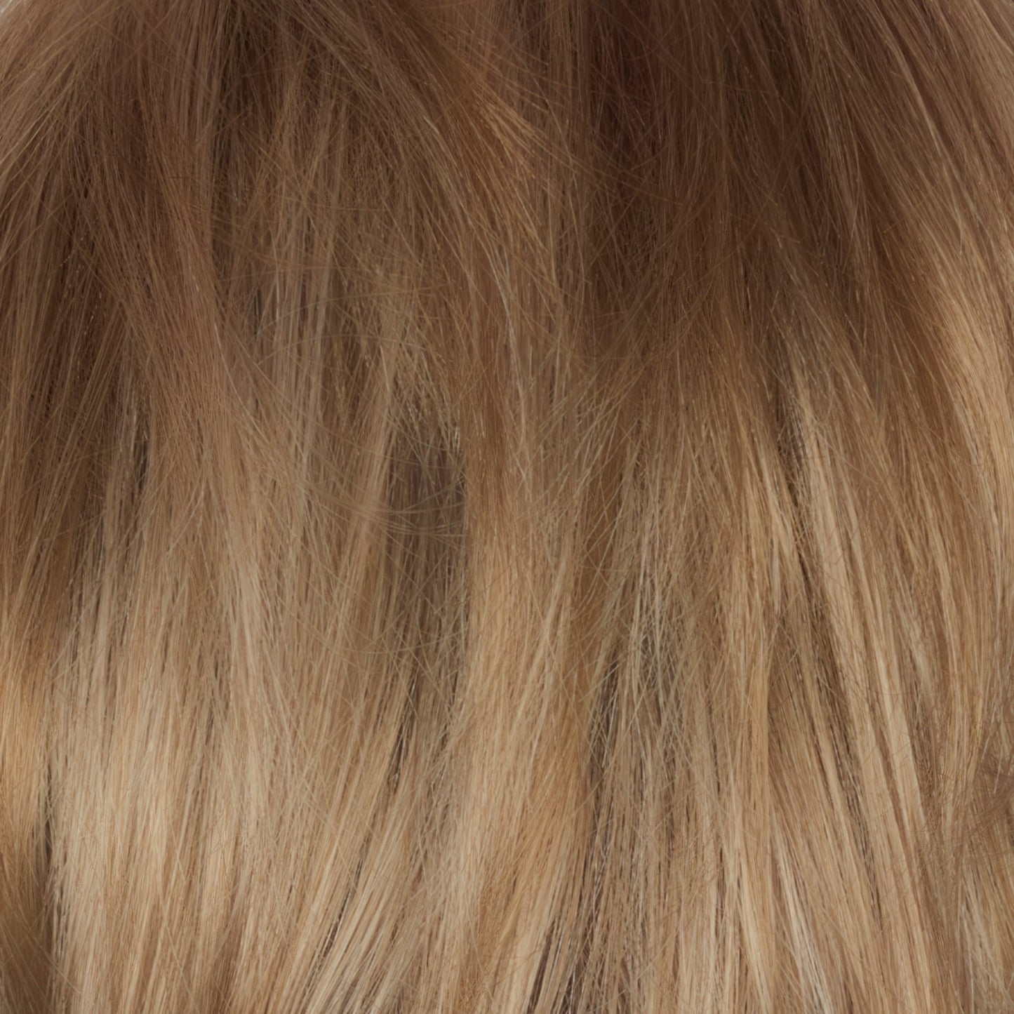 Champagne Sunset - A luxurious dark/medium multi-tonal blond with a chocolate brown root regrowth that captures the essence of a summer sunset. This beautiful color is ideal for those who appreciate textured honey, ash and gold hues.