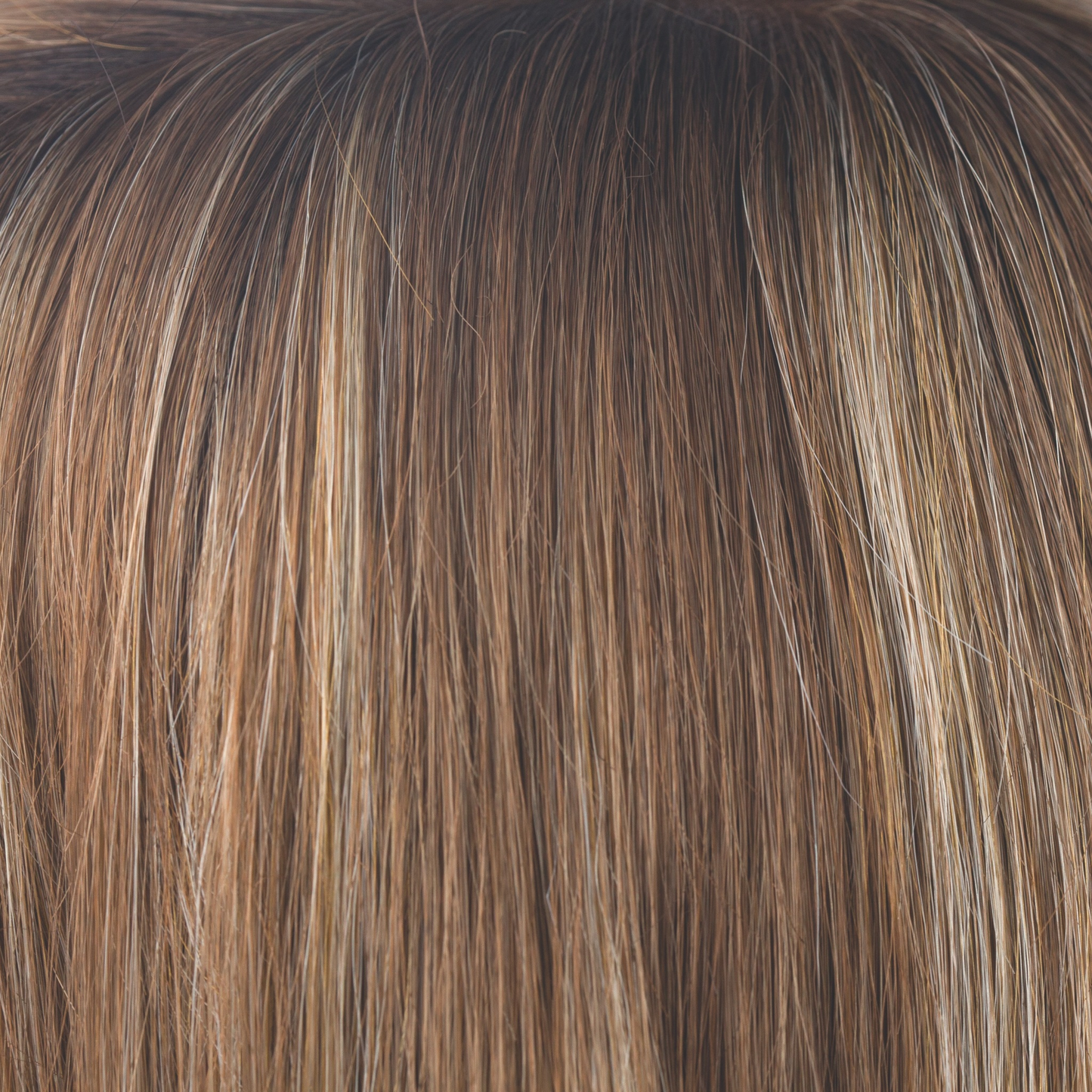 Maple Sugar-R - This dreamy color showcases a light, warm medium brown base with warm medium blond highlights. Warm, dark brown roots create any type of realistic length and style, making Maple Sugar-R a showstopper!