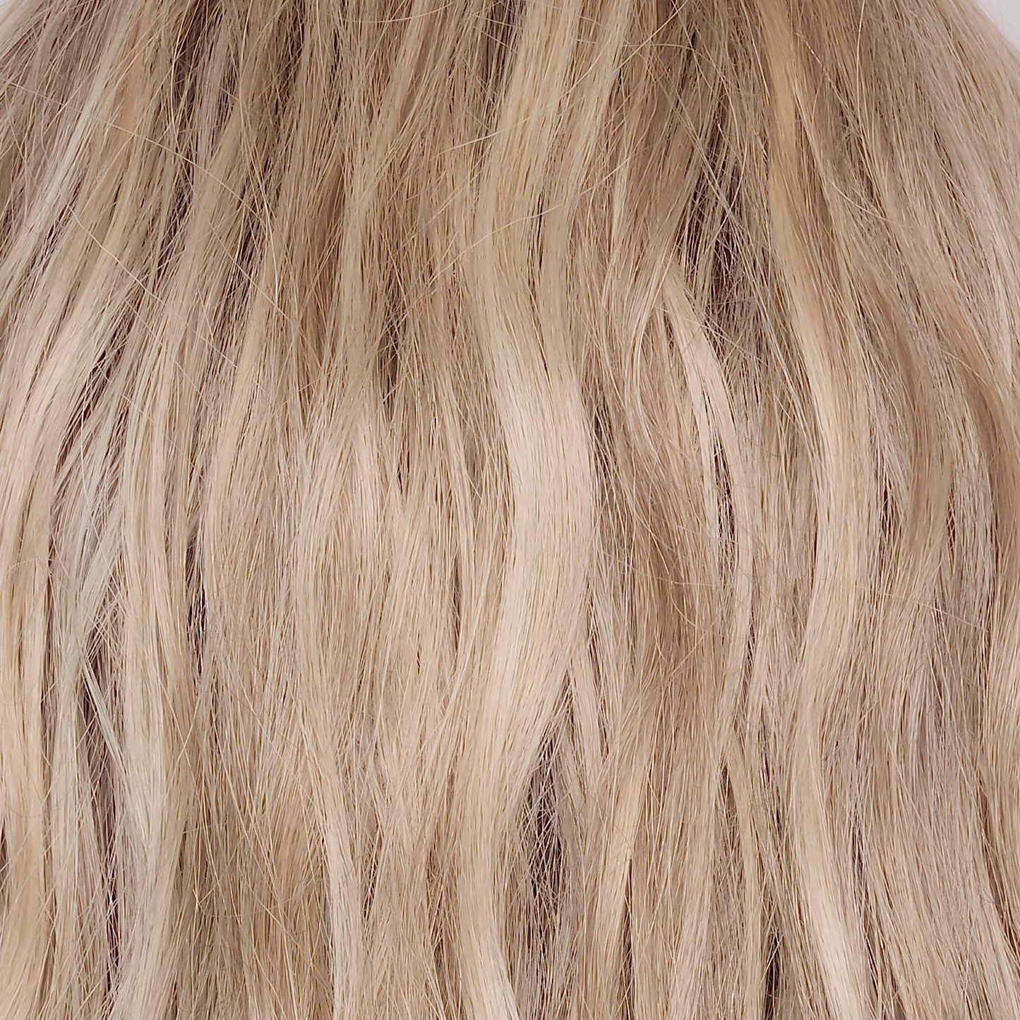Buttercream Blond-R  -  The rooted sister of Buttercream Blond is a stunning baby blond shade with a  warm chocolate root that exudes elegance and sophistication. The harmonious blend of light ash, medium honey, and pale gold hues creates a luxurious and radiant finish