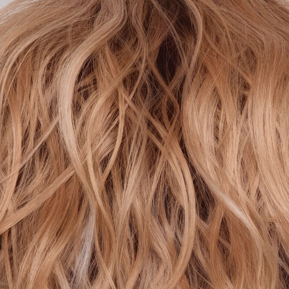 Peaches and Cream  -  A warm peach blonde base with creamy blonde undertone highlights. Face-framing highlights in a bright cream white blonde enhance the look, while a rich chocolate root regrowth adds depth and contrast.